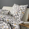 A close-up view of bedding with a polka dot pattern. Produktbild-Vorschau