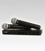 A black dual wireless microphone system with a receiver and two microphones, displayed on a light gray background. Podgląd zdjęcia produktu