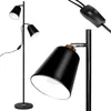 A black floor lamp with two adjustable heads and gold accents, shown against a white background. Náhled obrázku produktu