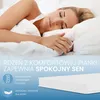 A woman sleeping peacefully on a bed, with promotional text and product imagery superimposed. Produktbild-Vorschau