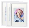 Three white picture frames are displayed side-by-side, with the rightmost frame showcasing a portrait of a young woman with colorful hair. Produktbild-Vorschau
