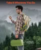 A man with a backpack is holding a green duffel bag while looking at his phone in a forest setting. Anteprima dell’immagine prodotto