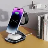 A wireless charging stand for a smartphone and smartwatch, with earbuds charging on the base, plugged into a wall socket. Books are visible on the right. Náhled obrázku produktu