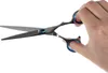 A hand holding a pair of scissors against a white background. Anteprima dell’immagine prodotto