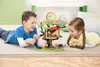 Two children are playing with a toy treehouse on the floor. Anteprima dell’immagine prodotto