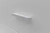 A close-up shot of a silver drawer pull on a white surface. Voir les images du produit
