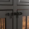 A close-up view of the latches and hinges of a dark-colored dog crate. Produktbild-Vorschau