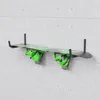 A snowboard is mounted on a wall rack against a concrete wall. Anteprima dell’immagine prodotto