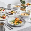 A table set for a meal with plates of food, drinks, and decorative elements. Produktbild-Vorschau