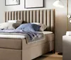 A close-up view of a bed with pillows and a blanket. Produktbild-Vorschau