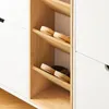 A close-up view of a white shoe cabinet with wooden shelves holding sandals. Náhľad obrázku produktu