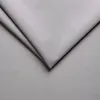 A close-up view of folded light gray fabric. Náhľad obrázku produktu