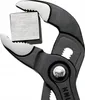 A close-up shot of a pair of pliers gripping a metal cube. Anteprima dell’immagine prodotto