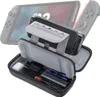 A protective case for a gaming console, shown open with accessories inside, and the console partially visible in the background. Produktbild-Vorschau