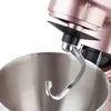 A close-up view of a rose gold stand mixer's dough hook and mixing bowl. Podgląd zdjęcia produktu