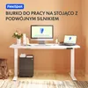 A modern standing desk setup with a computer monitor, laptop, and accessories on a white desk against an orange wall. Podgląd zdjęcia produktu