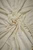 A crumpled off-white fitted sheet. Produktbild-Vorschau