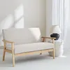 A beige two-seater sofa with wooden legs is shown in a well-lit room. Anteprima dell’immagine prodotto