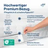 A hand is shown unzipping a mattress cover, with various feature callouts and icons. Produktbild-Vorschau