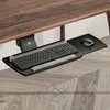 An under-desk keyboard and mouse tray attached to a wooden desk. Voir les images du produit