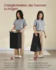 Two women demonstrating two different ways to carry a black laundry basket. Produktbild-Vorschau