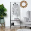 A clothing rack with clothes and shoes, next to a chair and a plant. Produktbild-Vorschau