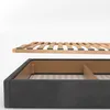A disassembled bed frame showing the wooden slats above the upholstered base. Produktbild-Vorschau