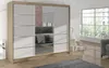 A modern bedroom with a large wardrobe and a window overlooking trees. Náhľad obrázku produktu