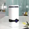 A white humidifier with a black accent and blue LED display sits on a white desk. Voir les images du produit