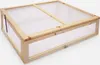 A wooden cold frame with a clear plastic lid. Produktbild-Vorschau