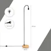 A minimalist floor lamp with a wooden base and a black gooseneck. Produktbild-Vorschau
