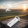 A drone and its battery are placed on a rock in a natural landscape during sunset. Náhled obrázku produktu