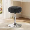 A black stool with a silver base is shown in a well-lit room with a window and curtains in the background. Produktbild-Vorschau
