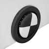 A close-up view of a circular black and white target-like emblem with LED lights around the edge, set into a white surface. Náhled obrázku produktu