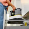 A person is placing a Kärcher cleaning device into a cabinet. Produktbild-Vorschau