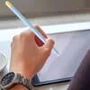 A hand holding a stylus over a tablet, with a watch on the wrist. Produktbild-Vorschau