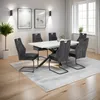 A dining room with a table and chairs set up on a rug. Produktbild-Vorschau