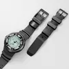 A black dive watch with a light green face and a detached black strap are shown on a white background. Podgląd zdjęcia produktu