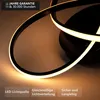 A close-up shot of a modern black LED ceiling lamp with a geometric design, illuminated with warm light. Produktbild-Vorschau