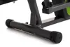 A close-up view of the base of a black and gray elliptical machine with green accents. Produktbild-Vorschau