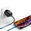 A black Ugreen USB wall charger is plugged into a white wall socket, and a black USB cable connects it to a smartphone that is charging. Anteprima dell’immagine prodotto