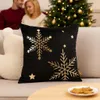 A couple sits on a couch near a decorated Christmas tree, with a snowflake-patterned pillow in the foreground. Voir les images du produit
