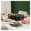 A raclette grill set up on a dining table with food and drinks, ready for a meal. Produktbild-Vorschau