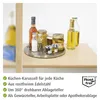 A rotating tray with various jars and bottles of food items on a wooden surface. Anteprima dell’immagine prodotto