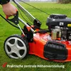 A person's hand is shown operating a lawnmower on a grassy field. Produktbild-Vorschau