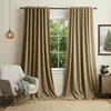 A cozy living room scene with a chair, curtains, and a window view. Anteprima dell’immagine prodotto