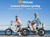 A couple riding electric bikes along a boardwalk by the sea. Produktbild-Vorschau