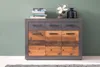 A sideboard with drawers and doors, decorated with books, a fan, and a vase. Voir les images du produit
