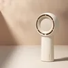 A close-up shot of a white handheld fan against a gradient background of light beige and white, with soft shadows. Anteprima dell’immagine prodotto