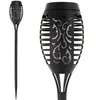 A black solar garden torch light with decorative cutouts is shown against a white background. The image is split into two views: a full view of the torch on the left and a close-up of the top section on the right. Voir les images du produit